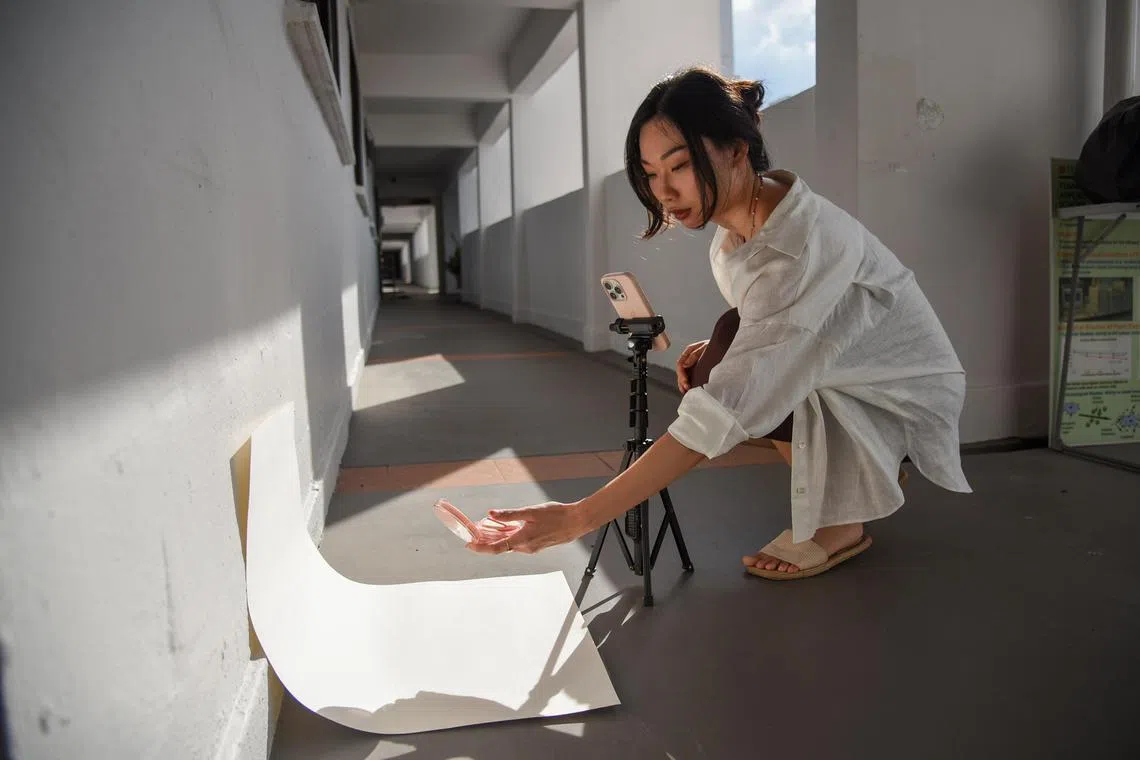 Ms Petrine Fong, 26, has had to get creative when photographing products for sponsored posts. She works in the corridor outside her HDB flat in Bedok.