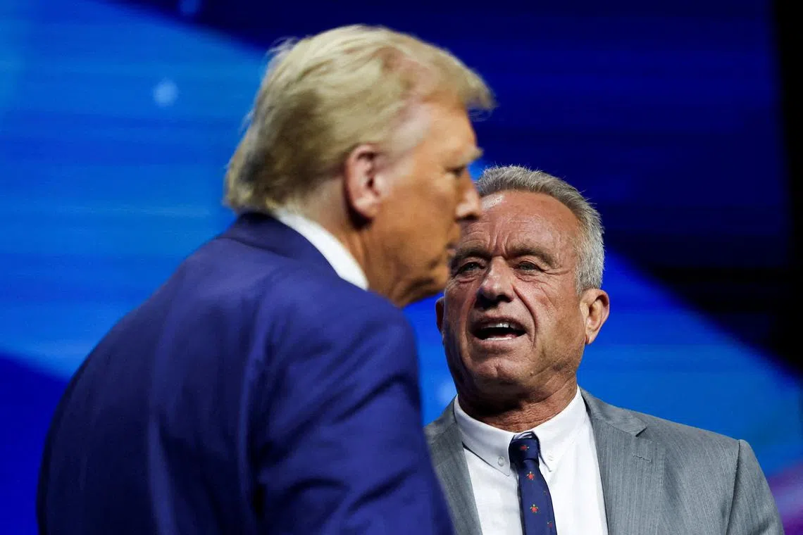 FILE PHOTO: Robert F. Kennedy Jr. and Republican presidential nominee and former U.S. President Donald Trump attend a campaign event sponsored by conservative group Turning Point USA, in Duluth, Georgia, U.S., October 23, 2024. REUTERS/Carlos Barria/File Photo
