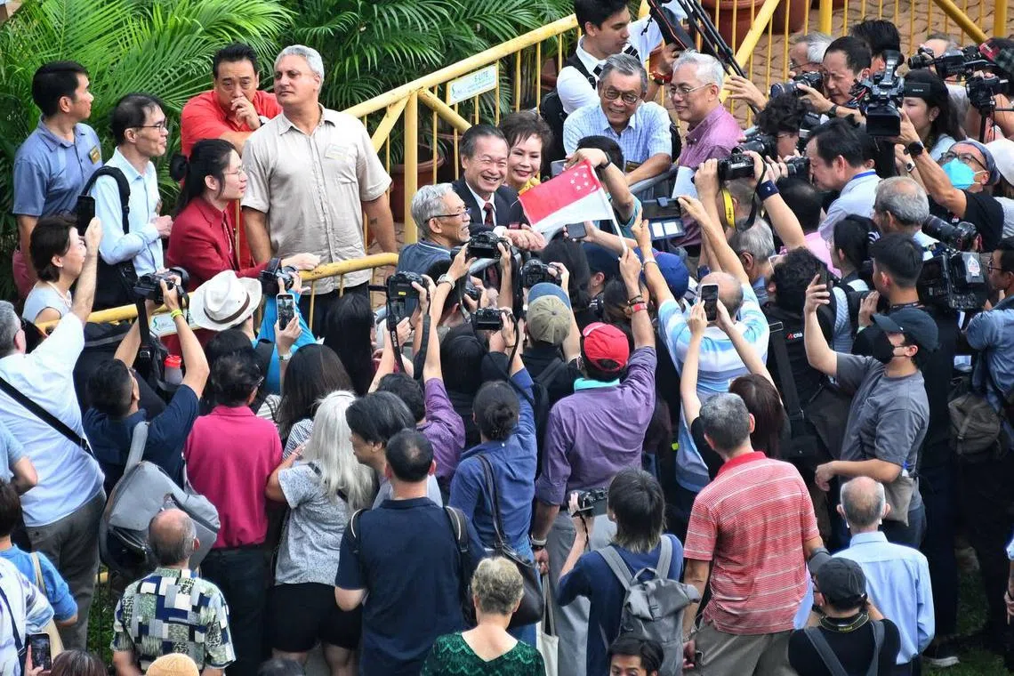 Tan Kin Lian shaking hands with his supporters. 