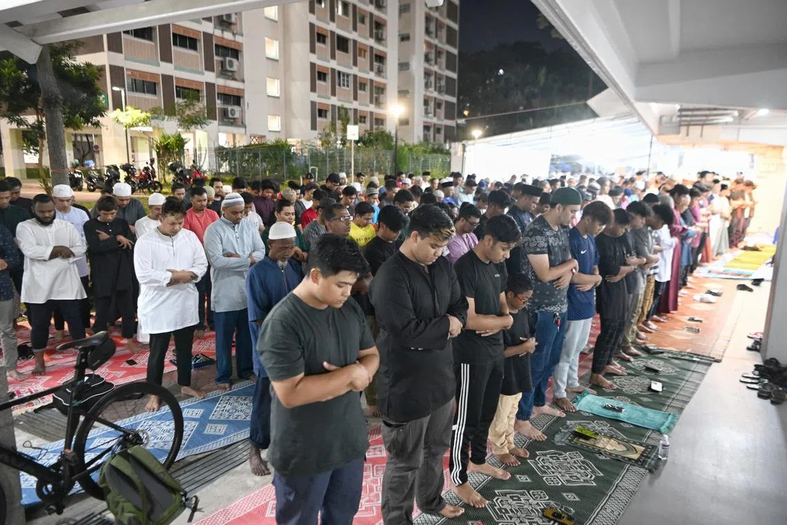 Tarawih prayers being carried out at the void deck of Block 450 in Tampines Street 42 on Thursday.