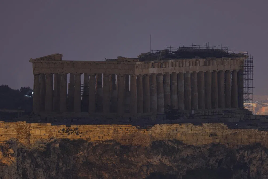 The ancient Parthenon temple atop the Acropolis hill during Earth Hour in Athens, Greece. 