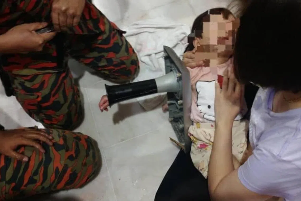 The toddler had put her hand deep into a speaker box’s hole and could not get it out. 