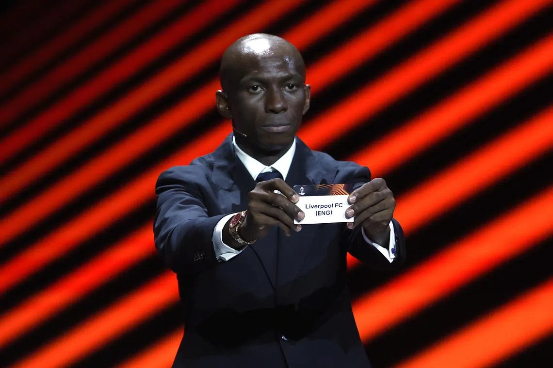 Cameroonian footballer Stephane Mbia showing a slip with Liverpool's name during the Europa League draw on Sept 1.