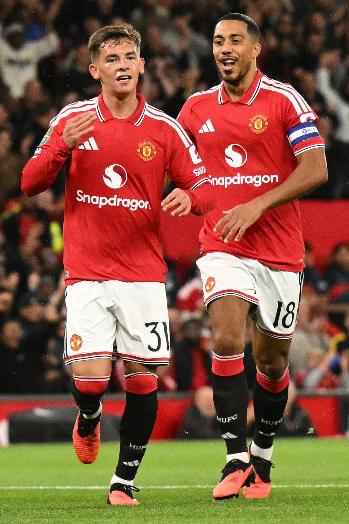 Manchester United’s midfielder Shea Lacey celebrates scoring the team’s first goal with teammate Youri Tielemans (right) during the match.
