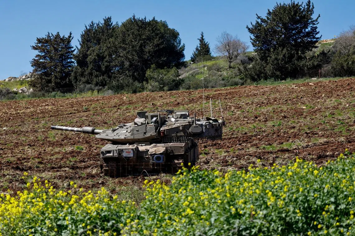 FILE PHOTO: Israeli tanks on the Israeli side of the Israel-Lebanon border, following an escalation between Hezbollah and Israel amid the U.S.-Israeli conflict with Iran, in northern Israel, March 8, 2026. REUTERS/Amir Cohen/File Photo