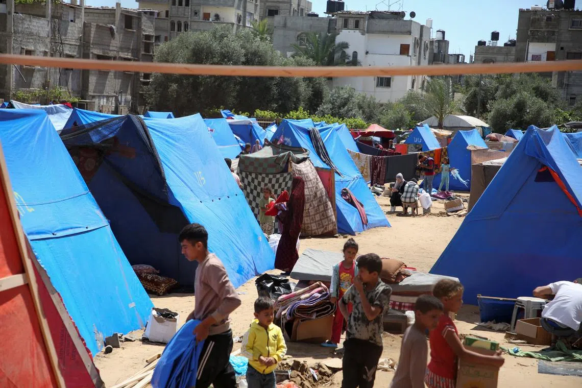 Displaced people look on after the Israeli military began evacuating Palestinian civilians ahead of a threatened assault on Rafah, amid the ongoing conflict between Israel and Hamas, in Rafah, in the southern Gaza Strip May 6, 2024. REUTERS/Hatem Khaled