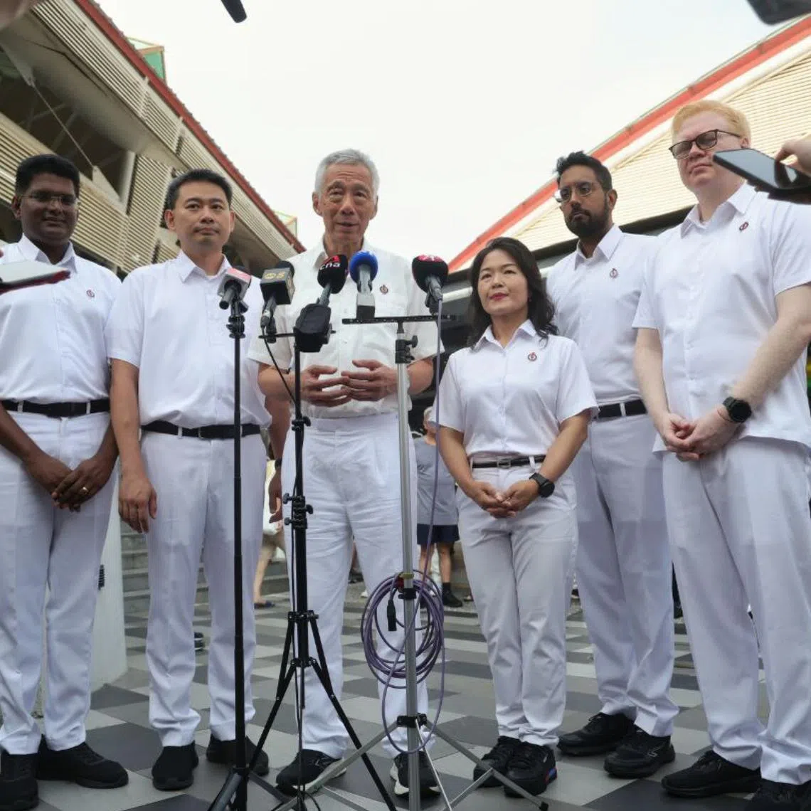 Senior Minister Lee Hsien Loong and the PAP Aljunied GRC team at 630 Bedok Reservoir Road Market and Food Centre on April 29.