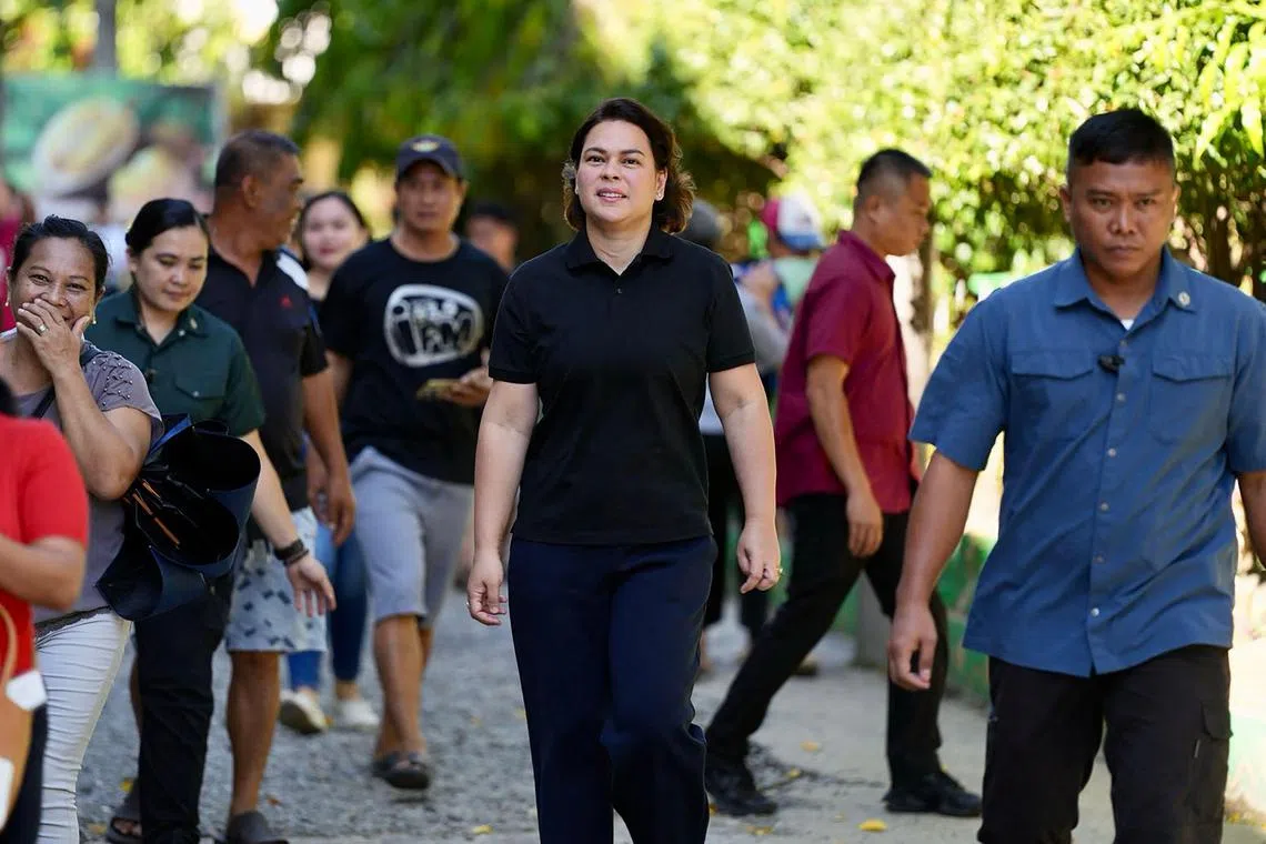This handout photo taken and released on May 12, 2025 and by the Office of the Vice-President of the Philippines shows Philippine Vice-President Sara Duterte arriving to vote in the mid-term election at a polling station in Davao City. Millions of Filipinos headed to the polls May 12 in a mid-term election widely seen as a referendum on the explosive feud between President Ferdinand Marcos and impeached Vice President Sara Duterte. (Photo by Handout / OFFICE OF THE VICE-PRESIDENT OF THE PHILIPPINES / AFP) / RESTRICTED TO EDITORIAL USE - MANDATORY CREDIT “AFP PHOTO / OFFICE OF THE VICE-PRESIDENT OF THE PHILIPPINES” - NO MARKETING NO ADVERTISING CAMPAIGNS - DISTRIBUTED AS A SERVICE TO CLIENTS