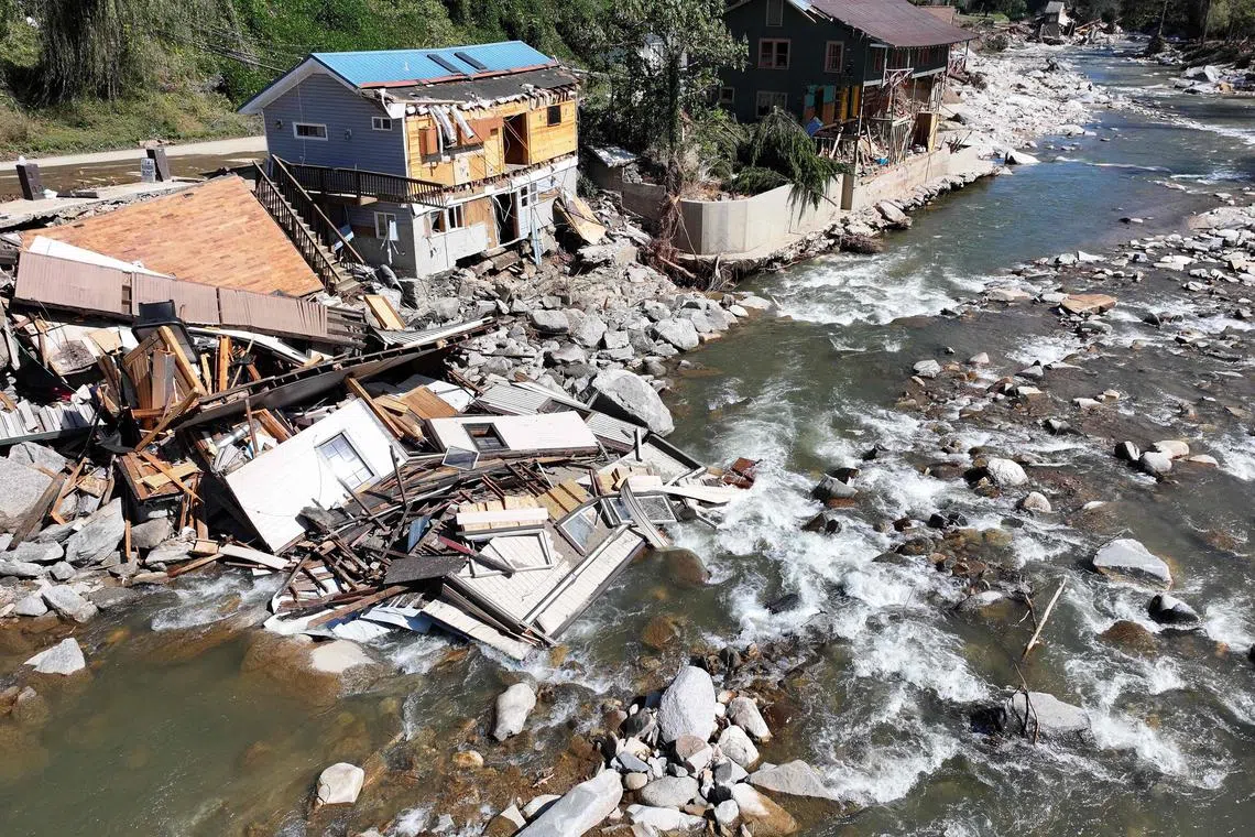 BAT CAVE, NORTH CAROLINA - OCTOBER 08: An aerial view of destroyed and damaged buildings in the aftermath of Hurricane Helene flooding on October 8, 2024 in Bat Cave, North Carolina. Bate Cave was particularly hard hit by flooding. Recovery efforts continue as the death toll has risen to over 230 while the powerful Hurricane Milton is on track to make landfall in Florida.   Mario Tama/Getty Images/AFP (Photo by MARIO TAMA / GETTY IMAGES NORTH AMERICA / Getty Images via AFP)
