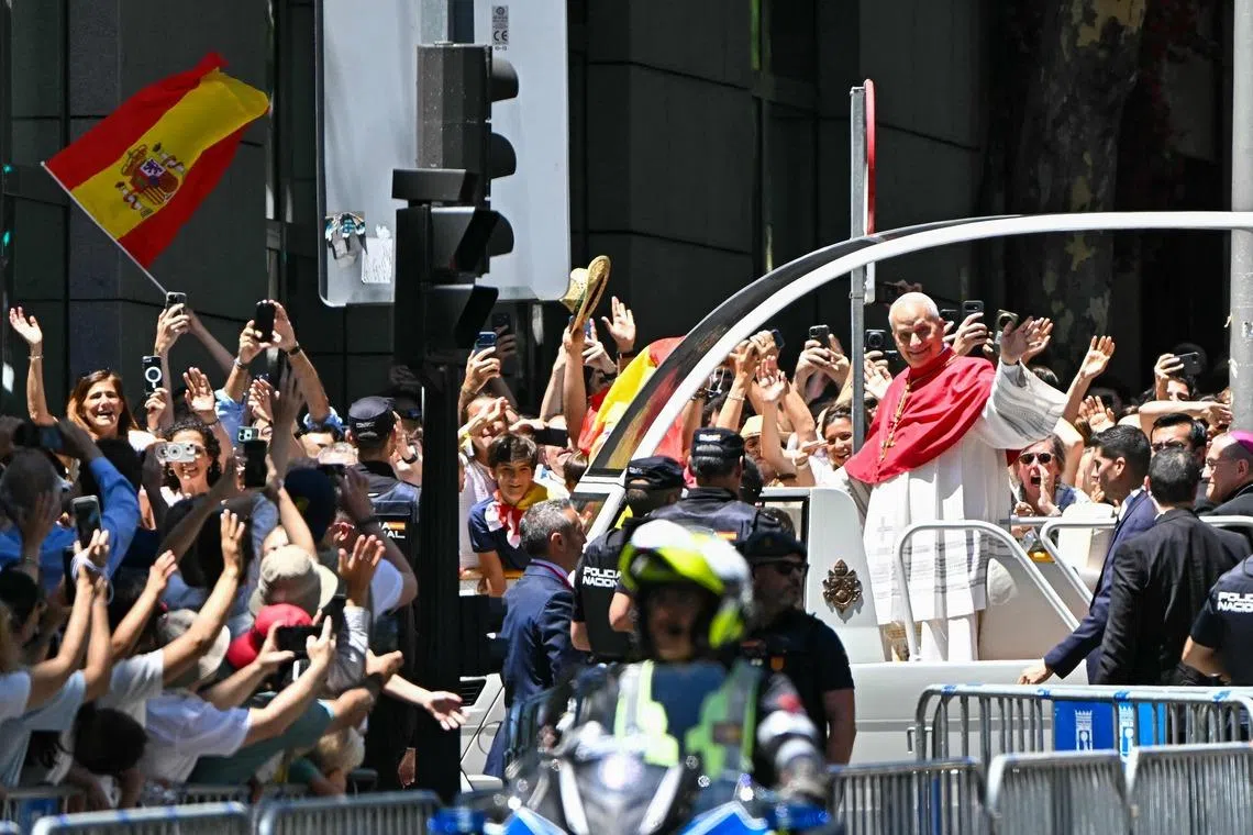 Pope Leo in Madrid on June 6. The pontiff has frequently been seen doing the 6-7 hand gesture on popemobile rides.