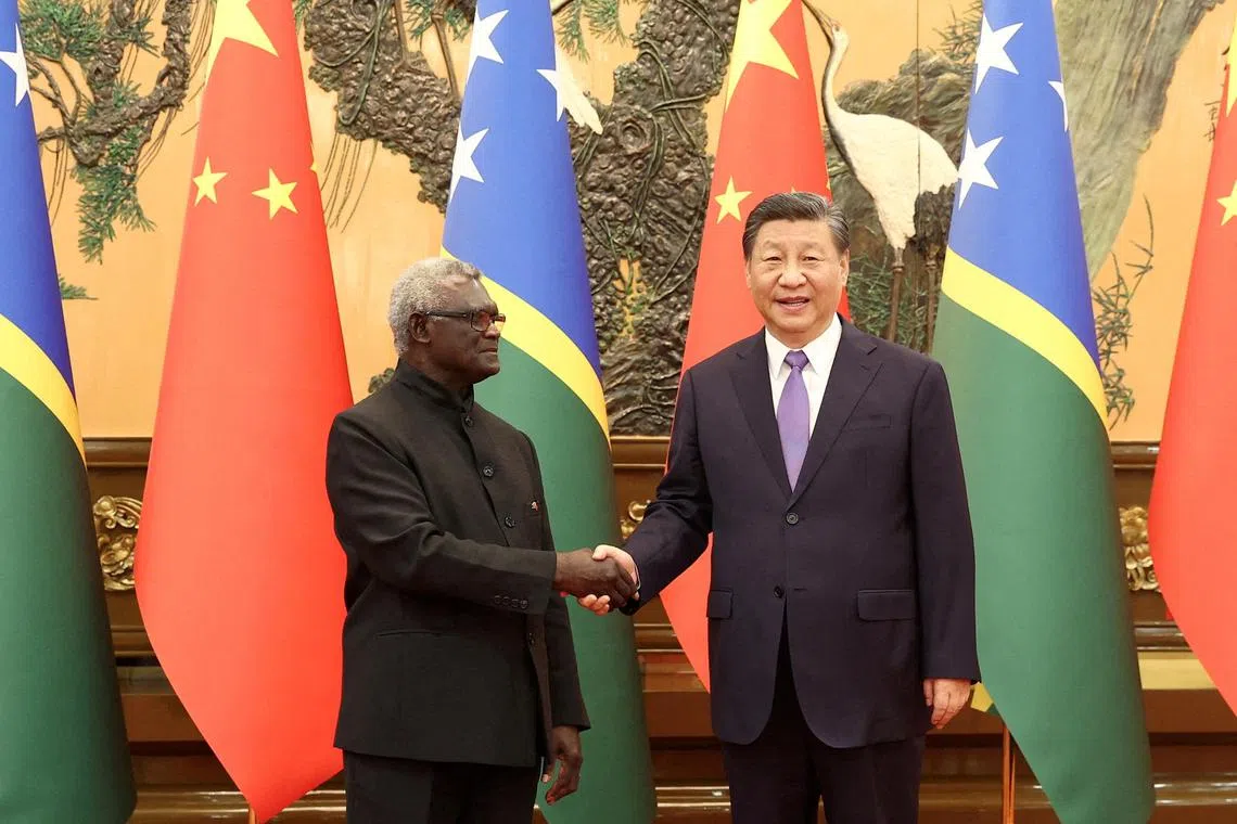 FILE PHOTO: Chinese President Xi Jinping and Solomon Islands Prime Minister Manasseh Sogavare shake hands at the Great Hall of the People in Beijing.