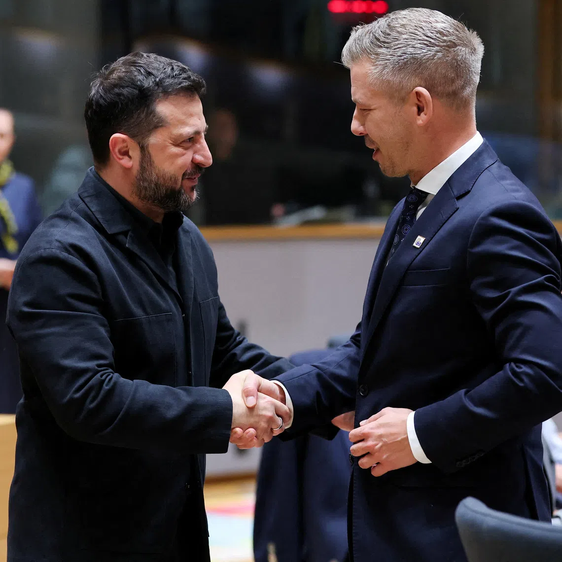 Ukraine's President Volodymyr Zelenskiy and Hungary's Prime Minister Peter Magyar greet each other during a European Union leaders summit in Brussels, Belgium October 16, 2026.  REUTERS/Stephanie Lecocq