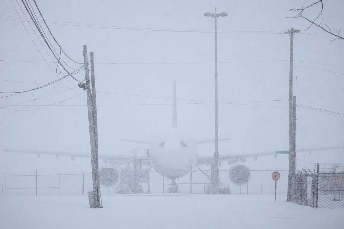 LOUISVILLE, KENTUCKY - JANUARY 5: A FedEx Corp. cargo jet sits parked in the snow at Louisville Muhammad Ali International Airport on January 5, 2025 in Louisville, Kentucky. Local forecasts called for heavy snowfall followed by significant accumulation of freezing rain and ice.   Luke Sharrett/Getty Images/AFP (Photo by LUKE SHARRETT / GETTY IMAGES NORTH AMERICA / Getty Images via AFP)