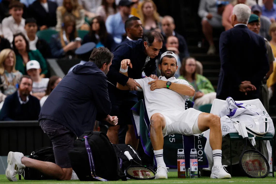 Tennis - Wimbledon - All England Lawn Tennis and Croquet Club, London, Britain - July 7, 2025 Bulgaria's Grigor Dimitrov receives medical attention after sustaining an injury during his round of 16 match against Italy's Jannik Sinner REUTERS/Andrew Couldridge