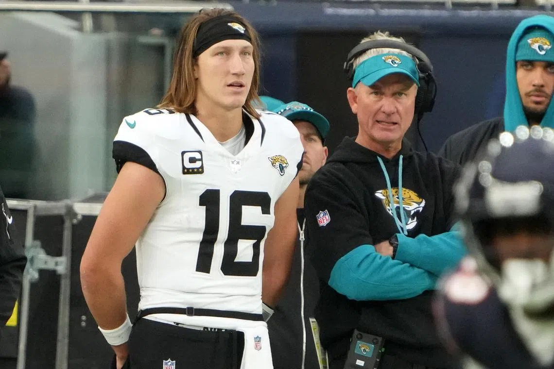 FILE PHOTO: Oct 13, 2024; London, United Kingdom; Jacksonville Jaguars quarterback Trevor Lawrence (16) and quarterbacks coach Mike McCoy watch from the sidelines in the second half during an NFL International Series game Chicago Bears atTottenham Hotspur Stadium. Mandatory Credit: Kirby Lee-Imagn Images/File Photo