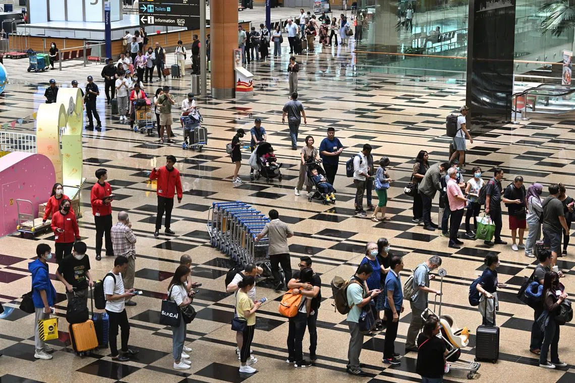 ST20230331-202382337387-Lim Yaohui-pixcheckpoint31/
Passengers queueing at the departure hall of Changi Airport Terminal 3 on Mar 31, 2023.
Delays are expected across some land and air checkpoints due to a disruption in the immigration clearance system.
The Immigration and Checkpoints Authority (ICA) announced the disruption on Facebook at 11.28am on Friday, adding that it “regrets the inconvenience caused to travellers and seeks their understanding and patience”.
In an update at 12.03pm, it advised travellers to postpone all non-essential travel.
(ST PHOTO: LIM YAOHUI)