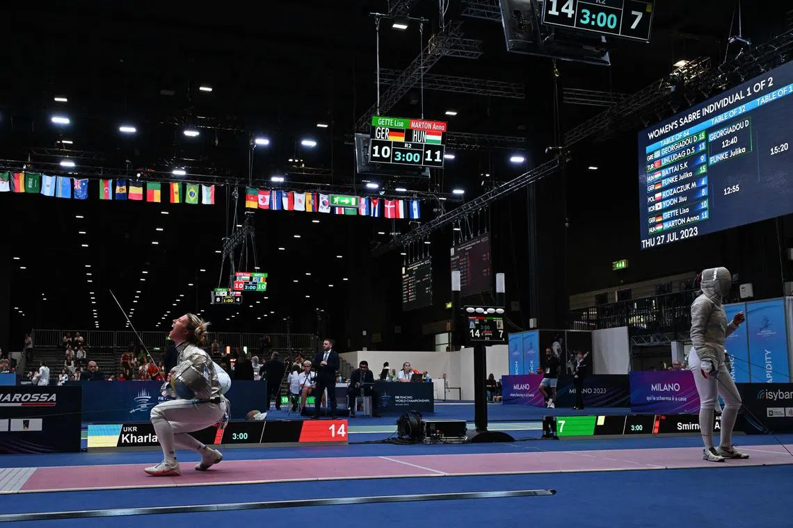 Ukraine's Olga Kharlan (left) celebrating after defeating Russia's Anna Smirnova, registered as an Individual Neutral Athlete (AIN), during the Sabre Women's Senior Individual qualifiers, as part of the FIE Fencing World Championships at the Fair Allianz MI.CO (Milano Convegni) in Milan, on Thursday.