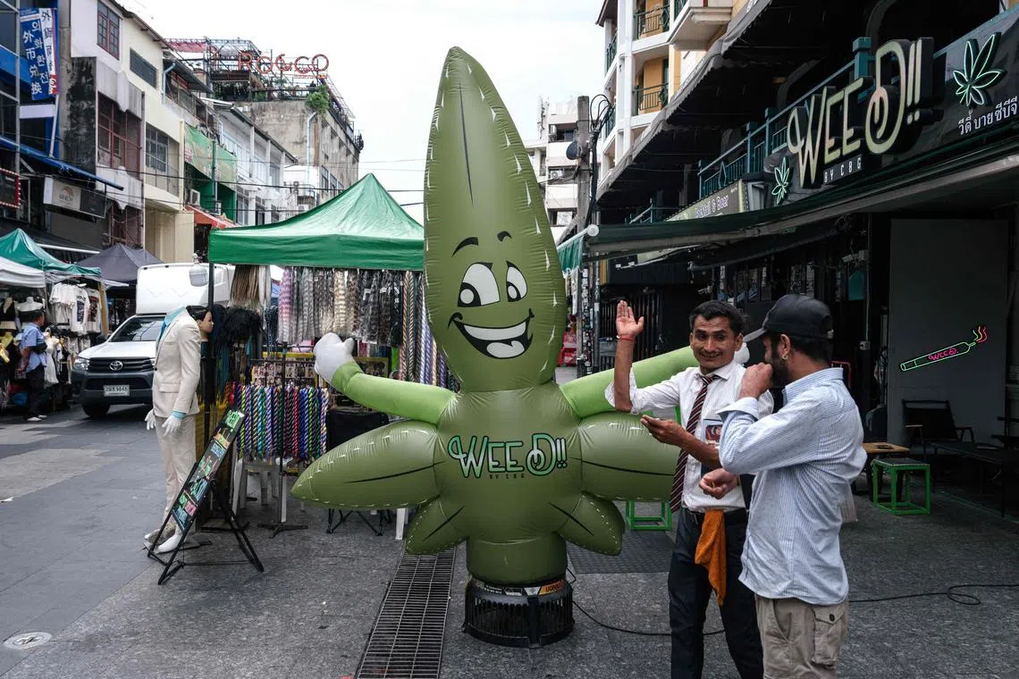 A marijuana leaf-shaped balloon is pictured in front of a cannabis dispensary on Khao San Road in Bangkok on May 23, 2025. 