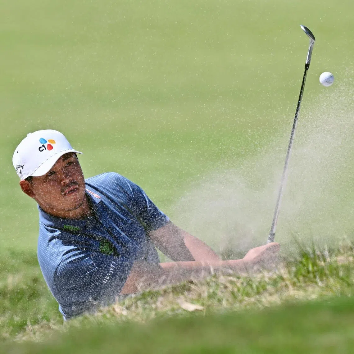 South Korea's Kim Si-woo hitting out of a bunker during the final round of the Australian Open golf tournament at the Royal Melbourne Golf Club in Melbourne on Dec 7, 2025.