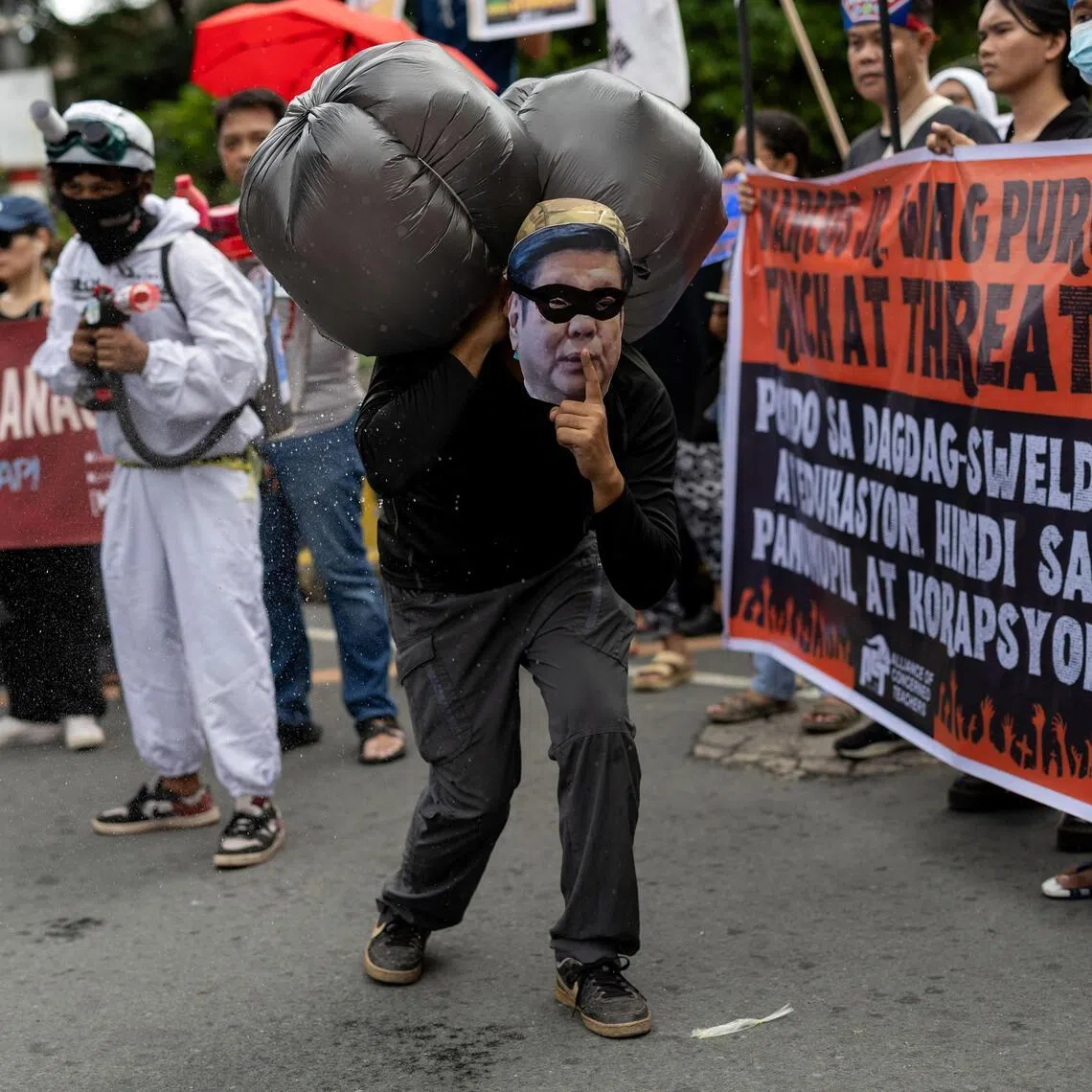 An activist posing in a costume depicting Philippine President Ferdinand Marcos Jr as a robber during a protest against government corruption in Manila, Philippines, on Oct 31, 2025.