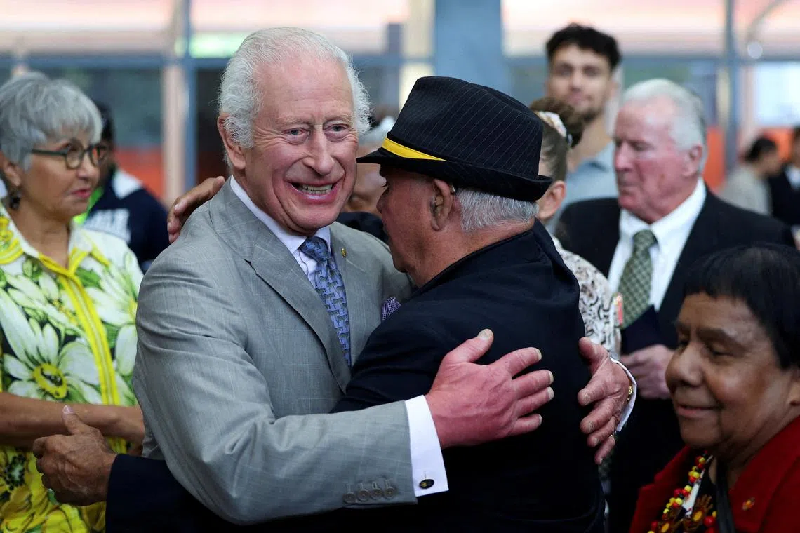 Britain's King Charles embraces Uncle James 'Michael' Widdy Welsh, a member of the Indigenous community, during a visit to the National Centre of Indigenous Excellence.