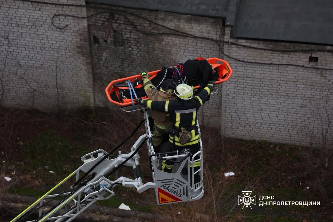 Rescuers evacuate a person from the site of a midday Russian missile strike, amid Russia's attack on Ukraine, in Dnipro, Ukraine December 1, 2025. Press service of the State Emergency Service of Ukraine in Dnipropetrovsk region/Handout via REUTERS