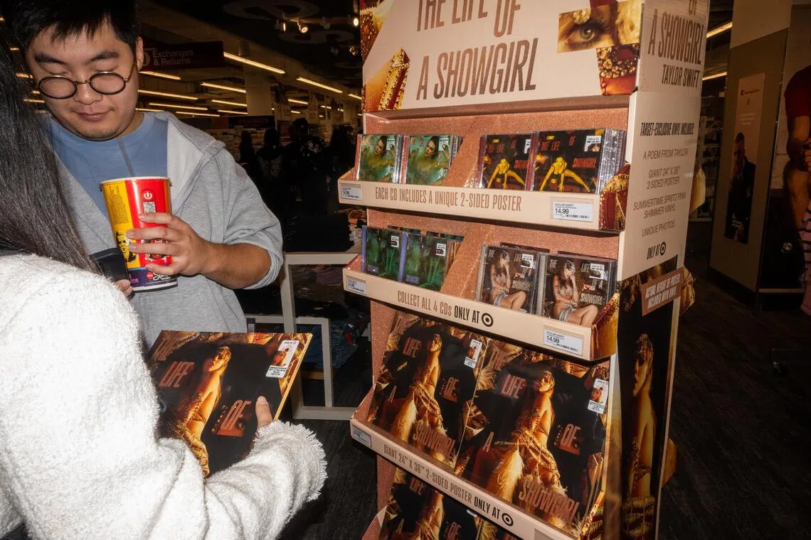 epa12428944 Fans look at copies of US singer Taylor Swift's album The Life of a Showgirl during the release party at Target in Times Square, in New York, New York, USA, 03 October 2025. Swift, one of the biggest pop stars in the world released her 12th studio album on 03 October.  EPA/JOHN TAGGART