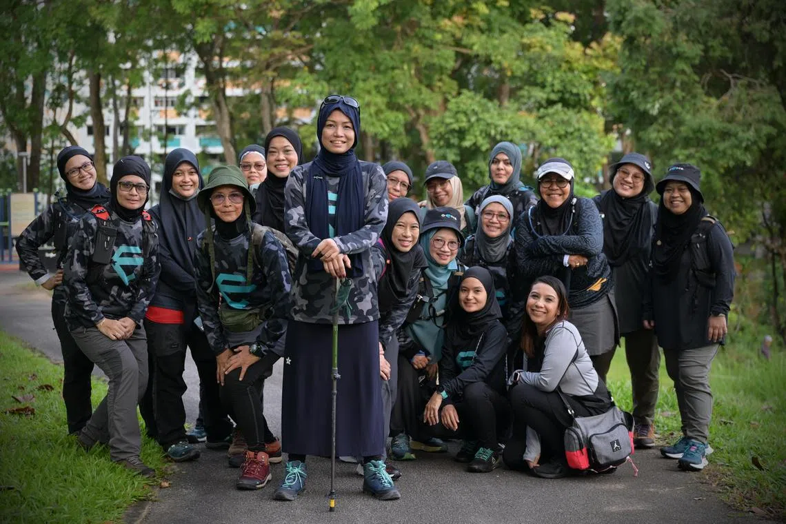 mtwomens/ST20240302_202471744962/Ng Sor Luan/ Muzdalifah Anuar from GEMS Singapore is one of the founders of a club that hosts running, netball and other activities for muslim women to get together to keep fit. Story on strong female leaders within the sporting community for International Women's day.