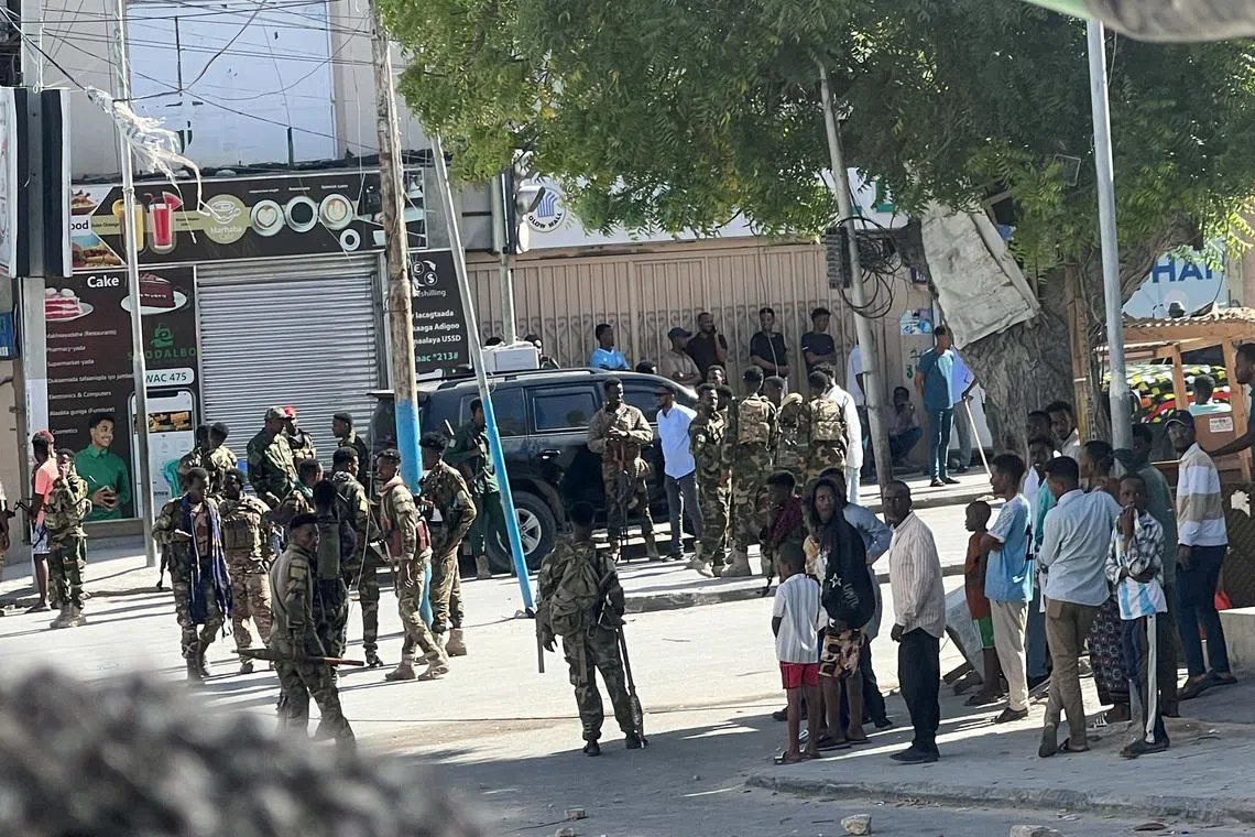 Members of Somali government forces stand among civilians at a street junction ahead of a planned protest against Somalia's President Hassan Sheikh Mohamud over his decision to remain in office after his term expired last month, in Mogadishu, Somalia, June 4, 2026. Picture taken with a mobile phone. REUTERS/Feisal Omar