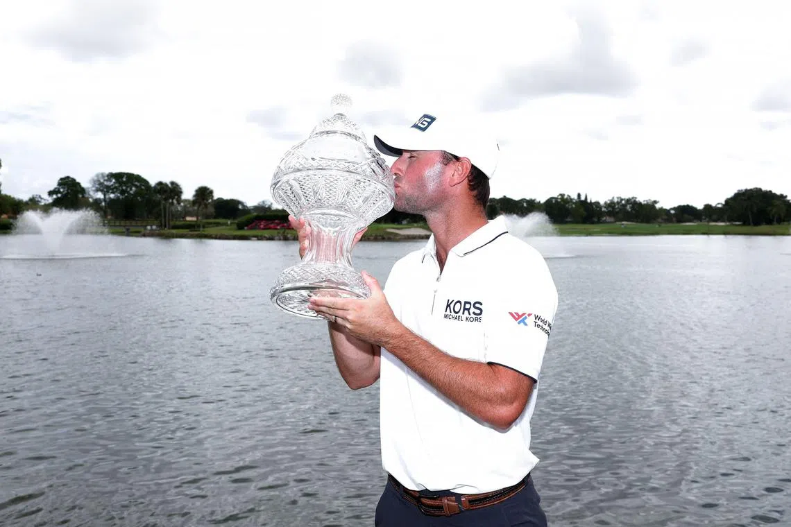 Austin Eckroat of the United States celebrating with the trophy at The Cognizant Classic.