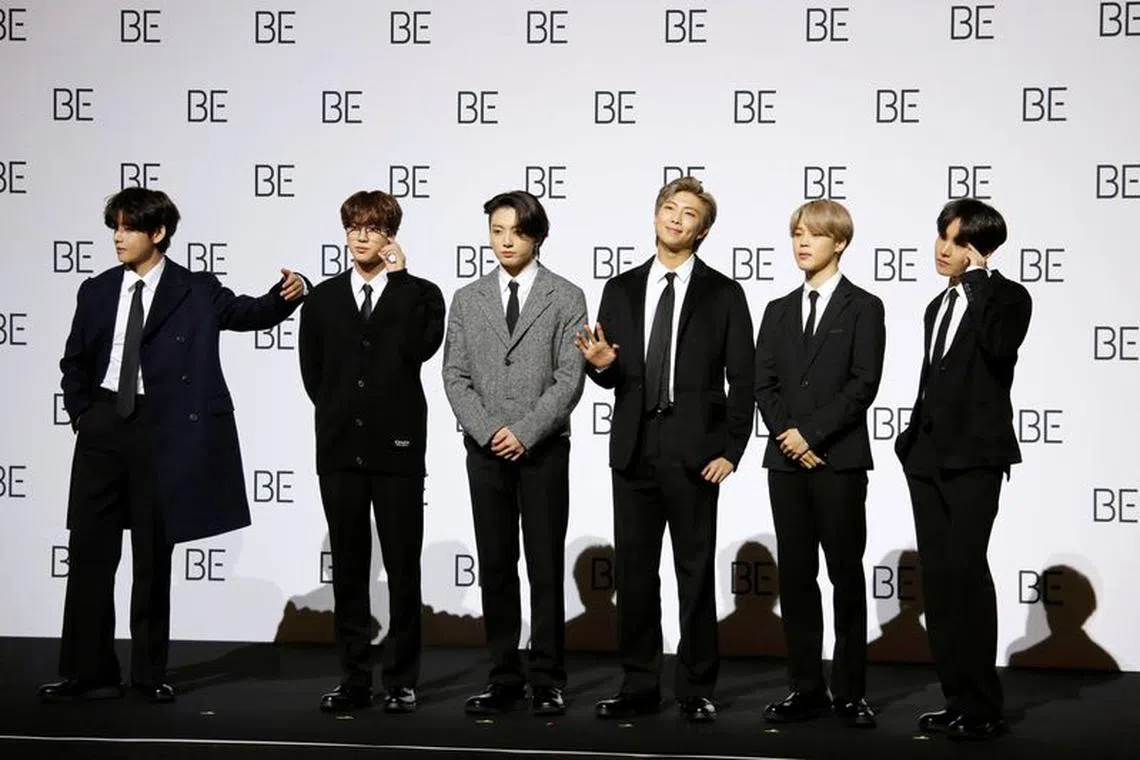 FILE PHOTO: Members of K-pop boy band BTS pose for photographs during a news conference promoting their new album \"BE(Deluxe Edition)\" in Seoul, South Korea, November 20, 2020. REUTERS/Heo Ran/File photo