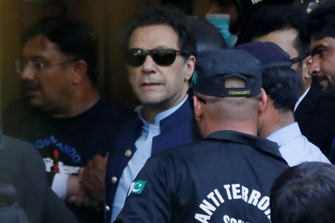 FILE PHOTO: Security officers escort Pakistan's former Prime Minister Imran Khan, as he appeared in Islamabad High Court, Islamabad, Pakistan May 12, 2023. REUTERS/Akhtar Soomro/File Photo