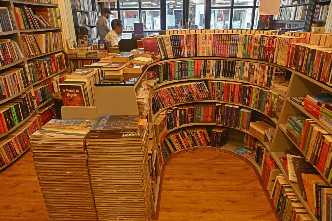 A shopkeeper waits for customers at a bookshop in Srinagar, India, on Aug 7. 