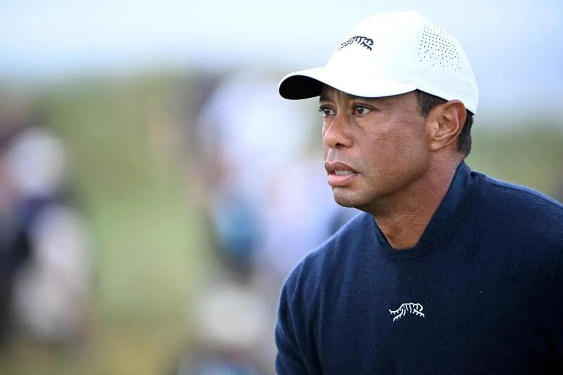 (FILES) US golfer Tiger Woods reacts after driving from the 4th tee during his second round, on day two of the 152nd British Open Golf Championship at Royal Troon on the south west coast of Scotland on July 19, 2024. Woods said on February 10, 2025 he was "just not ready" as he announced he will not play in this week's Genesis Invitational at Torrey Pines as planned following his mother's death. Woods had committed to his first professional tournament in seven months in the Genesis, a US PGA Tour event he hosts. His decision to play came just days after Woods announced his mother, Kultida, had died last week. (Photo by ANDY BUCHANAN / AFP) / RESTRICTED TO EDITORIAL USE