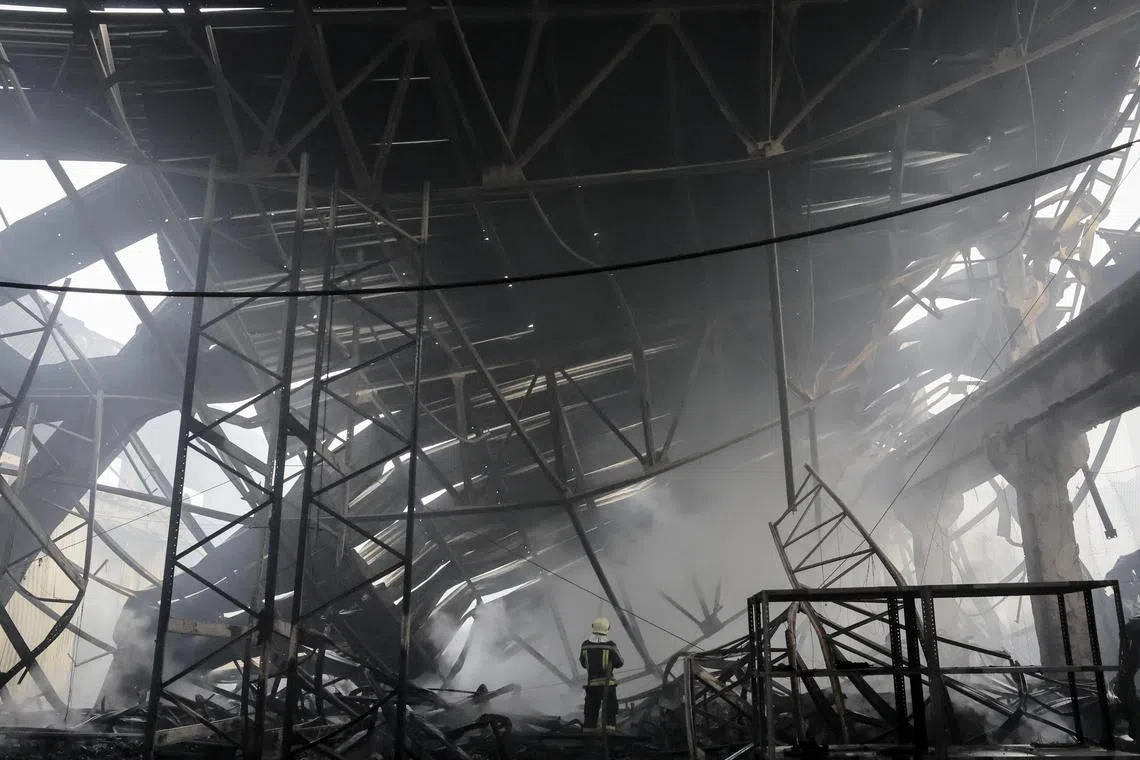 Ukrainian rescuers work at the site of a rocket attack on a civilian warehouse in Kyiv on Dec 29.