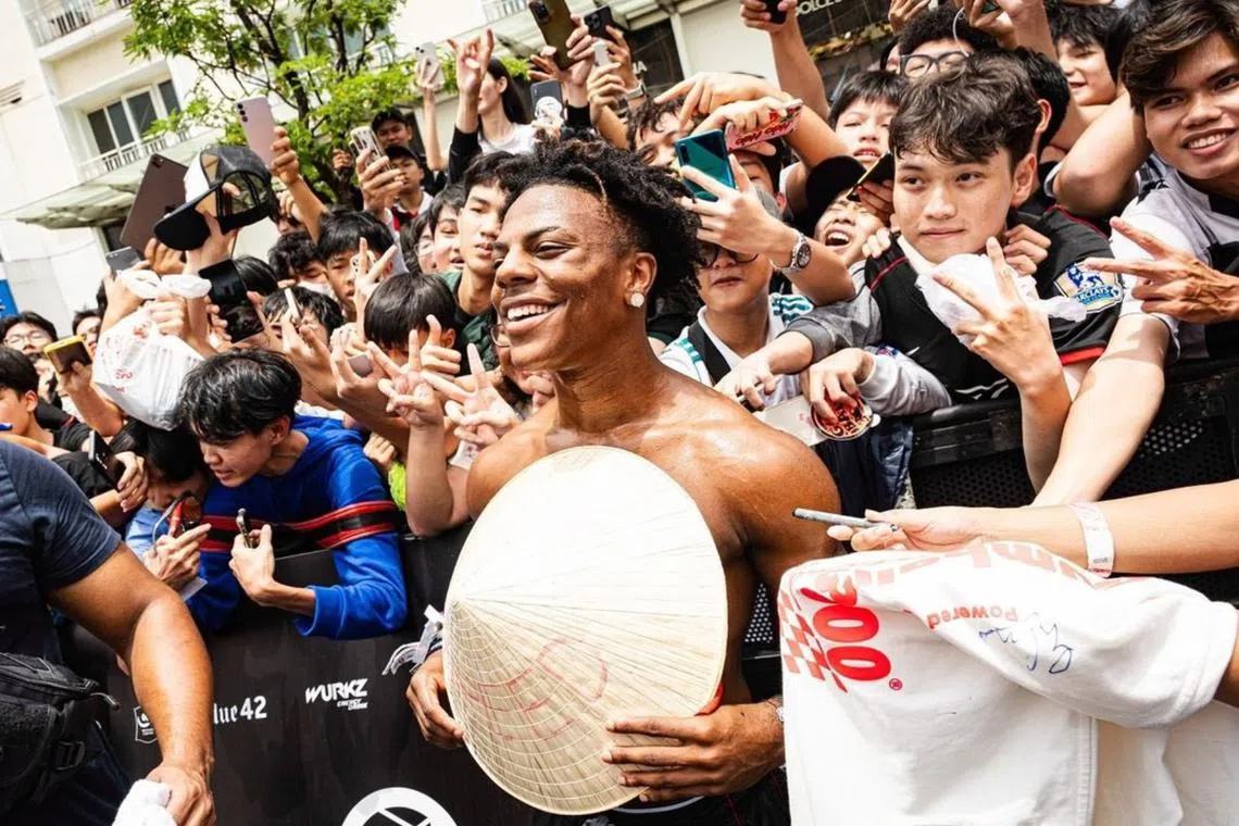 Speed takes photos with his fans at the Gumball 3000 event in Vietnam.