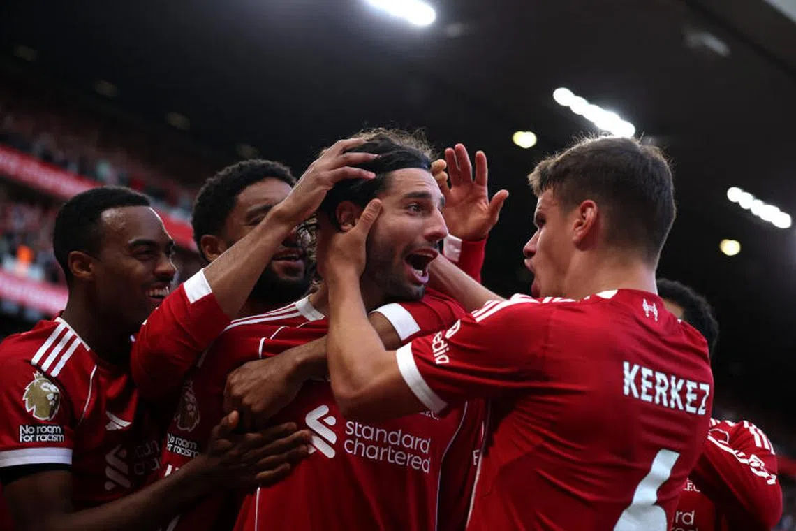 Liverpool's Dominik Szoboszlai celebrates scoring their first goal with Milos Kerkez, Joe Gomez and Ryan Gravenberch.
