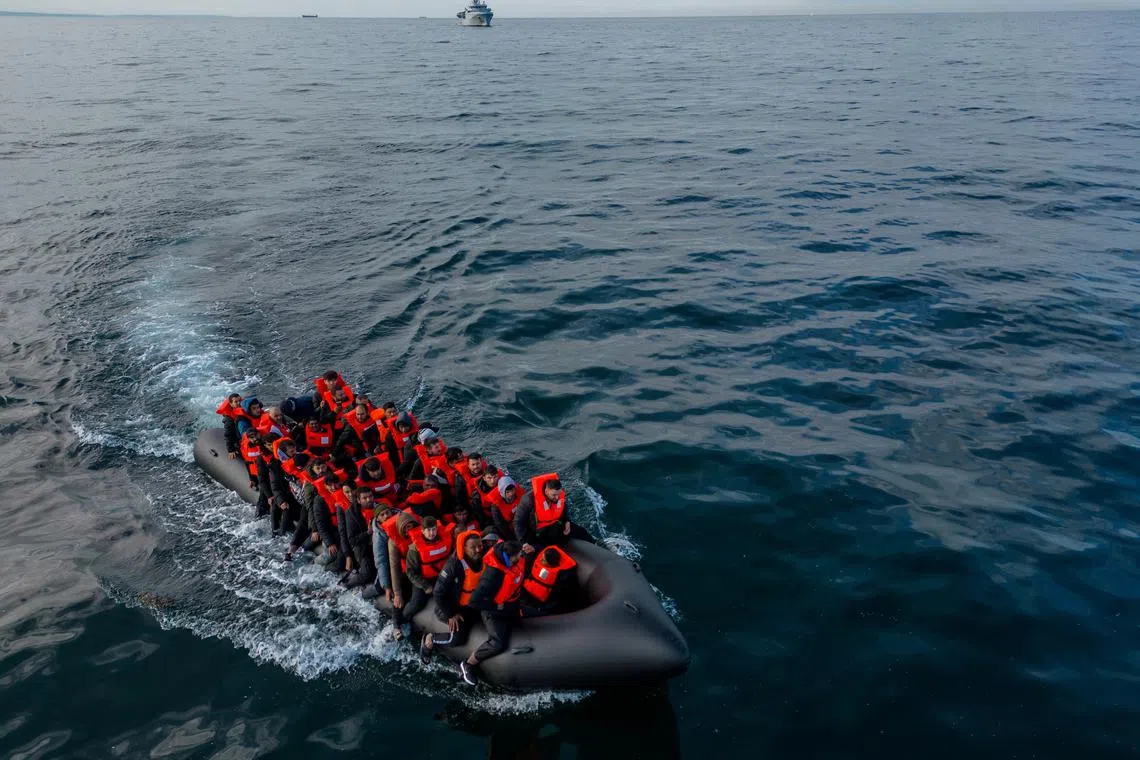 FILE PHOTO: In this drone view an inflatable dinghy carrying migrants makes its way towards England in the English Channel, Britain, May 4, 2024. REUTERS/Chris J. Ratcliffe/File Photo