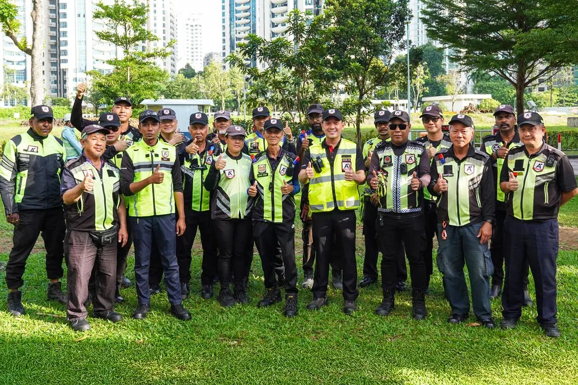 Mr Shane Shi (first row, fourth from right), managing director at A+ Officers Security, with members of his team. The company deploys 150 traffic marshals daily and has a client base of over 30 contractors that use their services regularly. 