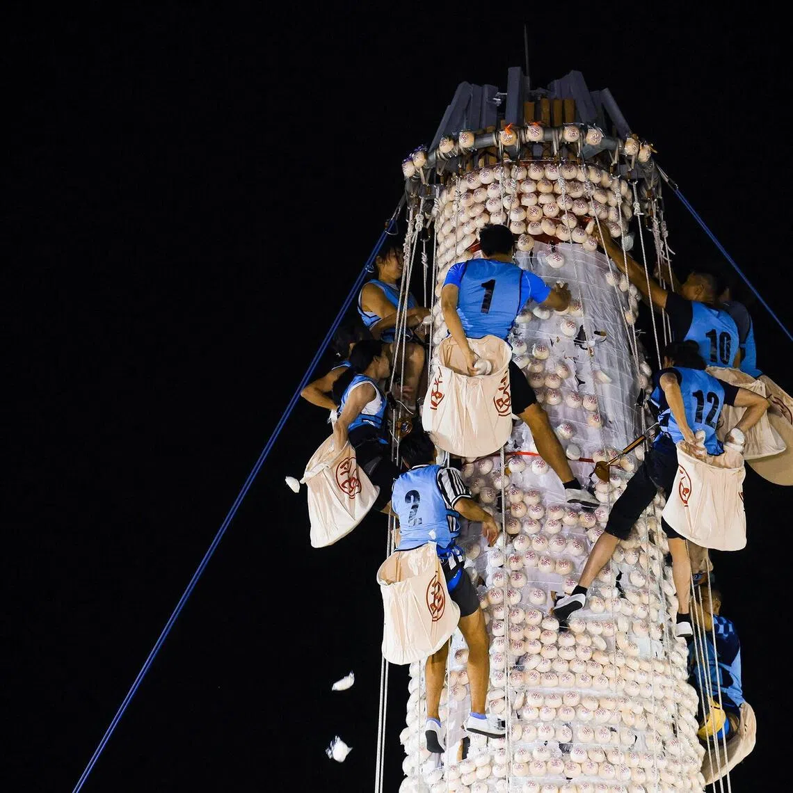 Cheung Chau Bun Festival features a Bun Scrambling Competition where athletes climb a tower covered in 9,000 plastic buns to grab as many as possible.