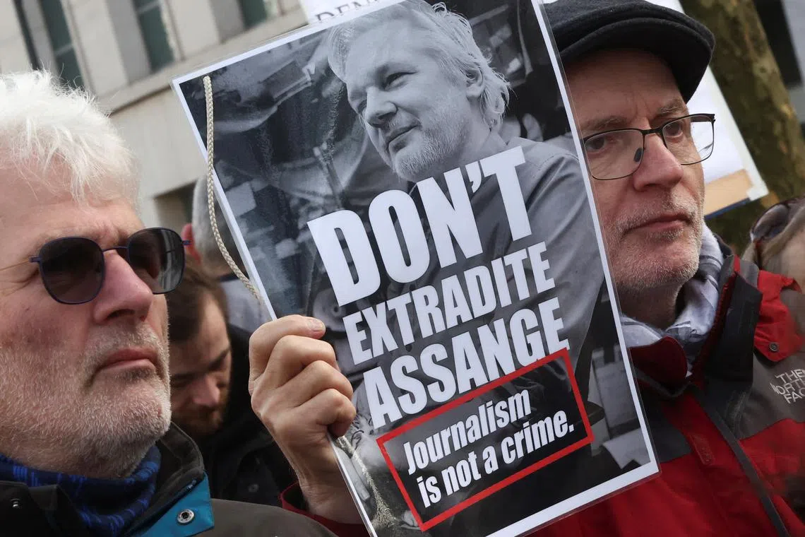FILE PHOTO: People take part in a protest outside the U.S. embassy in Brussels as the WikiLeaks founder Julian Assange's last-ditch appeal against his extradition to the U.S. is heard in London, in Brussels, Belgium February 20, 2024. REUTERS/Yves Herman/File Photo
