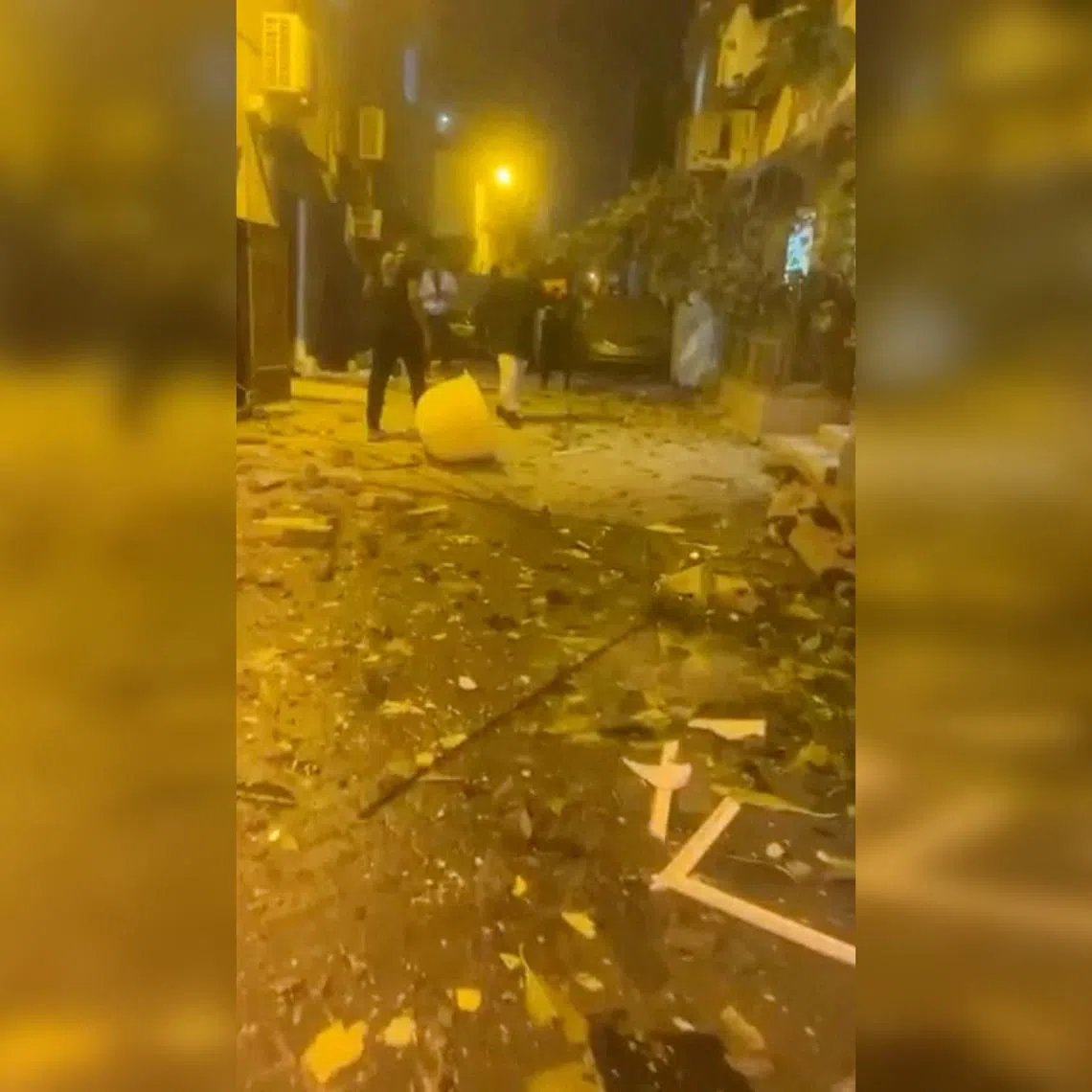 A video screengrab showing debris on the street after reported Iranian drone strikes in Sitra, Bahrain, on March 9.