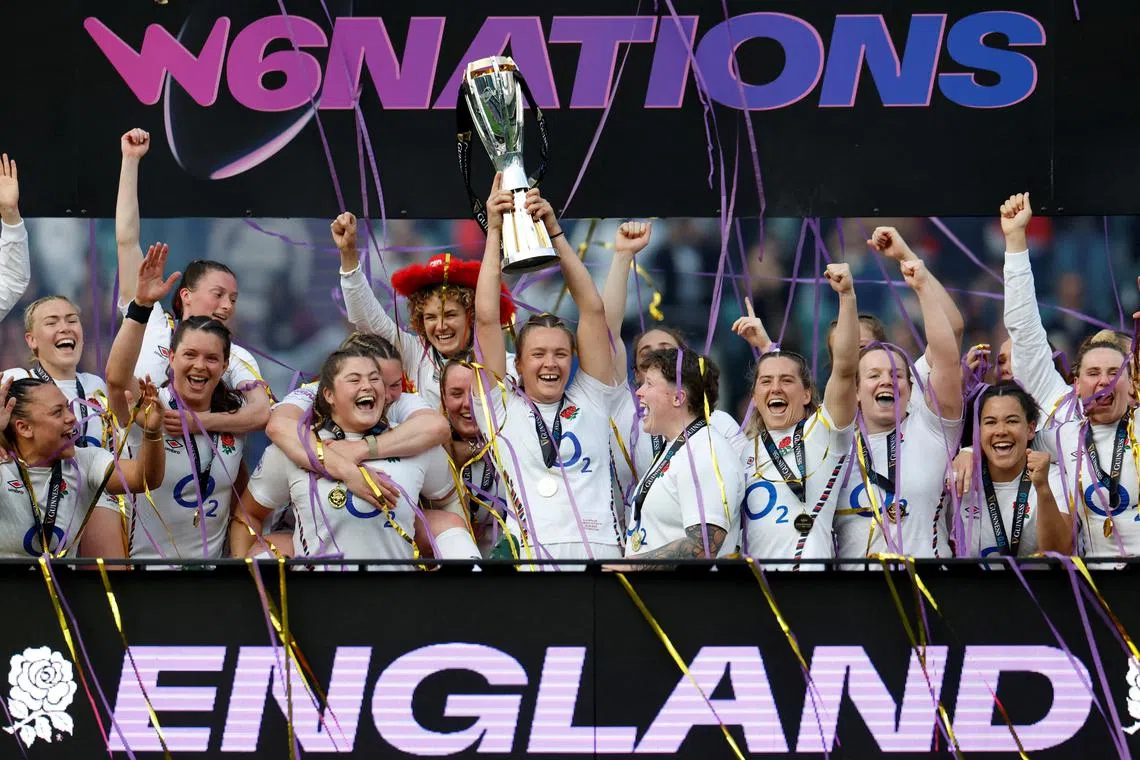 FILE PHOTO: Rugby Union - Women's Six Nations - England v France - Allianz Stadium, Twickenham, London, Britain - April 26, 2025 England's Zoe Aldcroft lifts the trophy as she celebrates with her team mates on the podium Action Images via Reuters/Peter Cziborra/File Photo