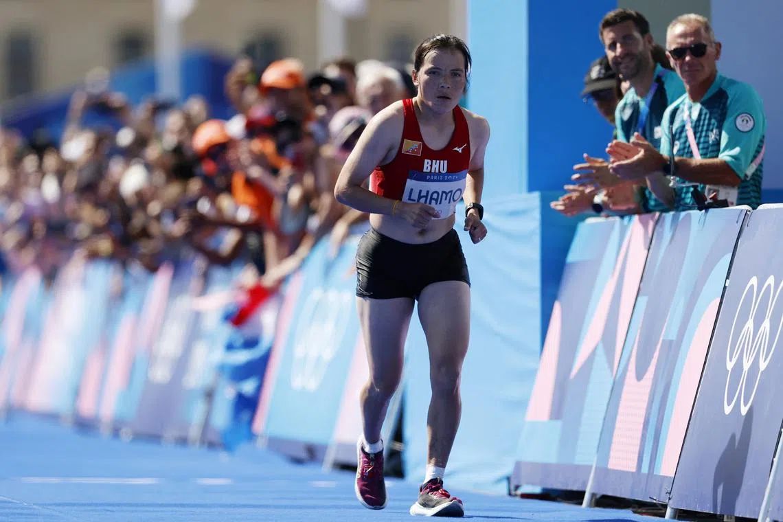 Paris 2024 Olympics - Athletics - Women's Marathon - Paris, France - August 11, 2024. Kinzang Lhamo of Bhutan in action before finishing the race. REUTERS/Lisa Leutner