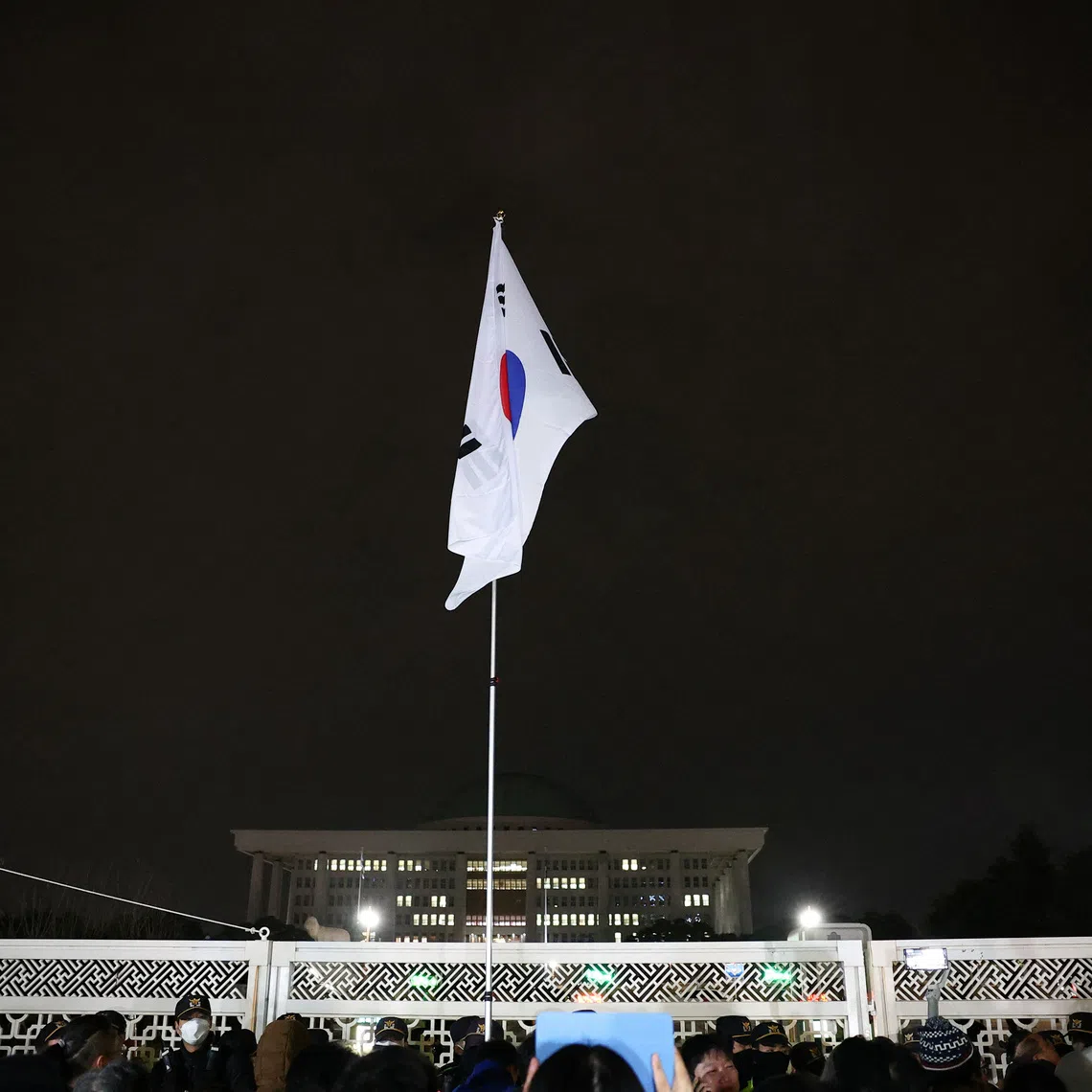 South Korean flag hangs on a pole outside the gate of the National Assembly, on Dec 4, 2024.