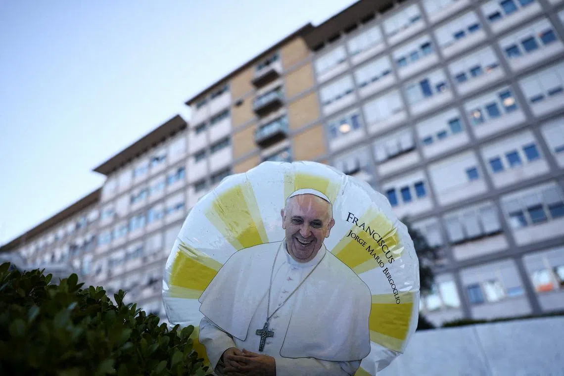 A balloon with an image of Pope Francis floats outside Gemelli Hospital, where Pope Francis is admitted for treatment, in Rome, Italy, March 4, 2025. REUTERS/Yara Nardi