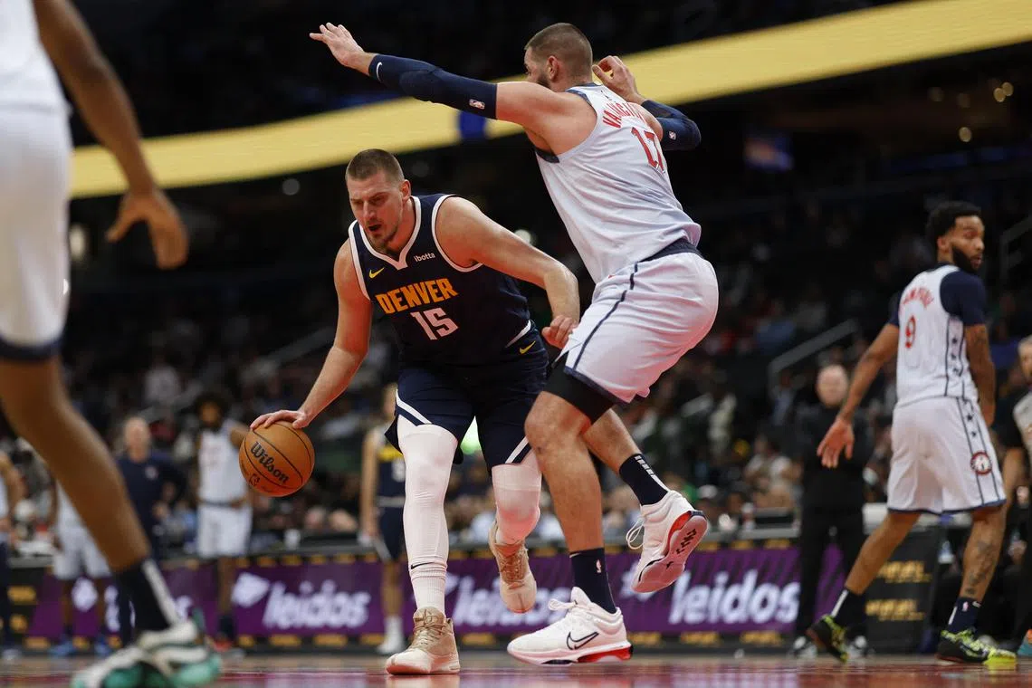 Denver Nuggets centre Nikola Jokic drives to the basket as Washington Wizards centre Jonas Valanciunas defends in the second quarter at Capital One Arena.