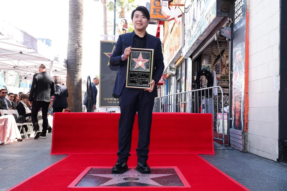 Chinese pianist Lang Lang poses for photos during the unveiling ceremony of his star on the Hollywood Walk of Fame in Los Angeles, California, U.S., April 10, 2024. REUTERS/Mario Anzuoni


