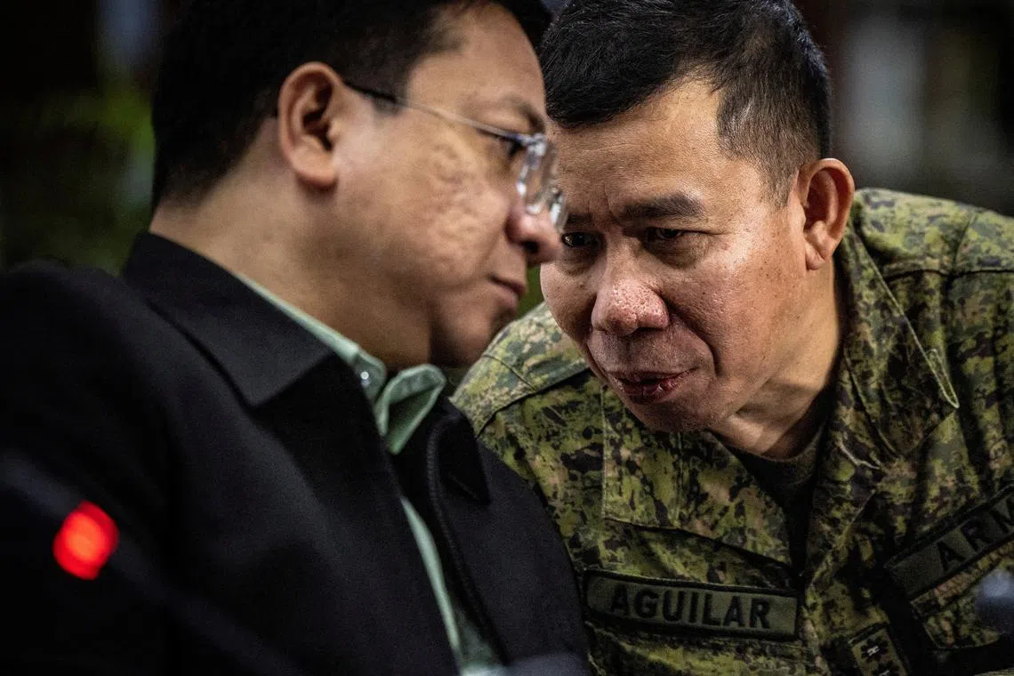 FILE PHOTO: Colonel Medel Aguilar (right), spokesperson for the Armed Forces of the Philippines, whispers to Jonathan Malaya, spokesperson for the National Security Council, as they take part in a press conference in response to recent aggression of the Chinese Coast Guard against Philippine vessels in the South China Sea, at the Department of Foreign Affairs in Manila, Philippines, August 07, 2023. Ezra Acayan/Pool via REUTERS/File Photo