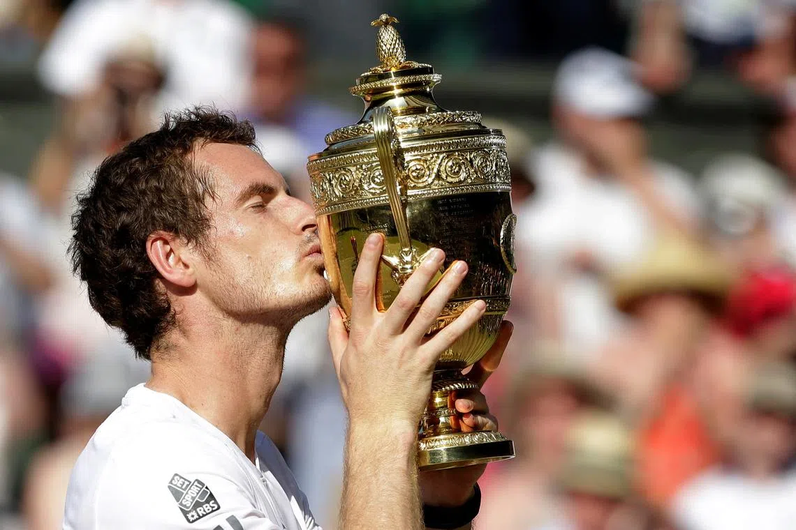 FILE PHOTO: Andy Murray of Britain kisses the winners trophy after defeating Novak Djokovic of Serbia (R) in their men's singles final tennis match at the Wimbledon Tennis Championships, in London July 7, 2013. REUTERS/Anja Niedringhaus/Pool/File Photo